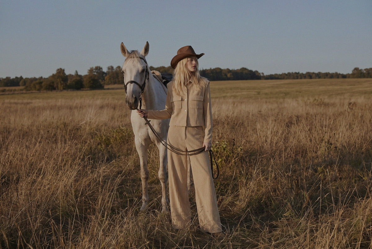 WU TANG Autumn/Winter 2026 — a model and horse in an open field