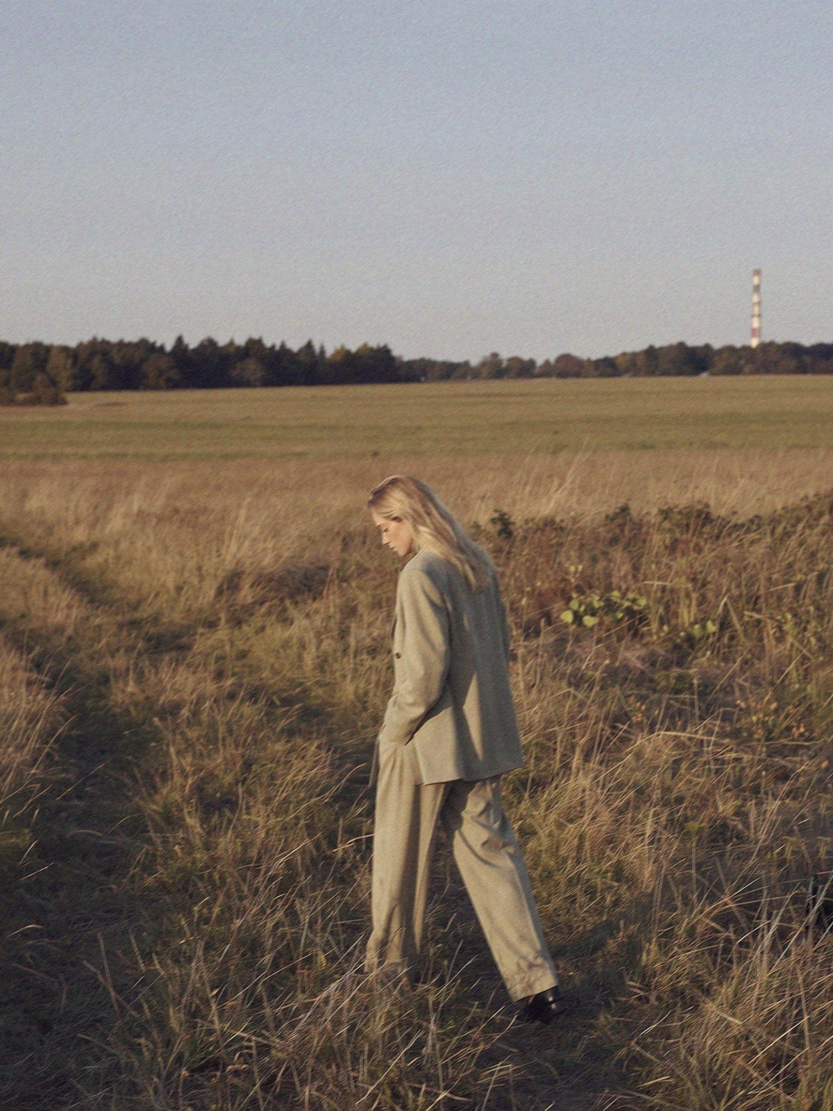 WU TANG Autumn/Winter 2026 — a model walking through a field in a light taupe suit